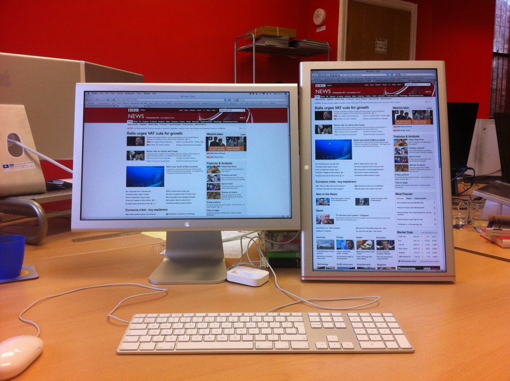 Two Apple studio monitors, one portrait, one landscape